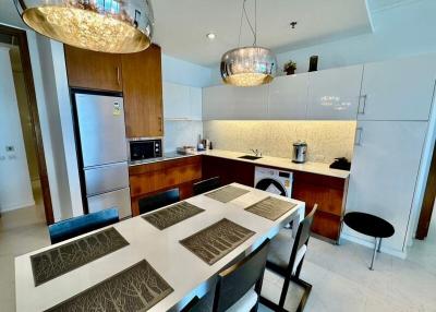 Modern kitchen with dining area and stylish lighting