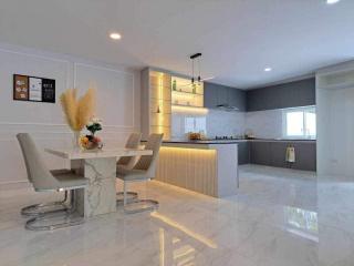 Modern kitchen with dining area, sleek design, and bright lighting