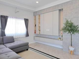 Modern living room with gray sofa and decorative shelves