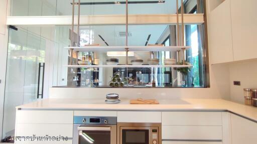 Modern kitchen with stainless steel appliances and floating shelves