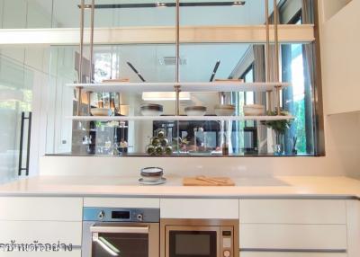 Modern kitchen with stainless steel appliances and floating shelves
