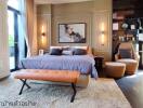 Elegant bedroom with large bed, seating, and artwork