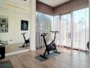 Home gym with exercise equipment in a bright room