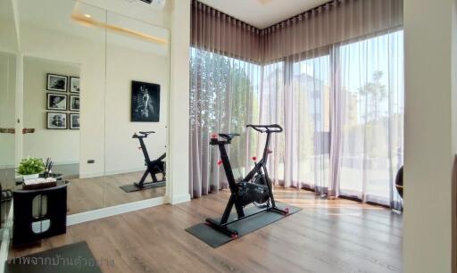 Home gym with exercise equipment in a bright room