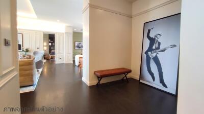 Spacious hallway with modern art decor and hardwood flooring
