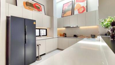 Modern kitchen interior with clean counters and art on the wall