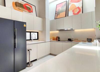Modern kitchen interior with clean counters and art on the wall