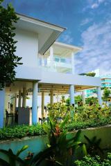 Modern two-story building with garden and balconies