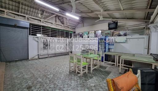 Spacious indoor area with dining tables and fluorescent lighting