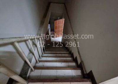 Staircase leading to upper level with wooden door