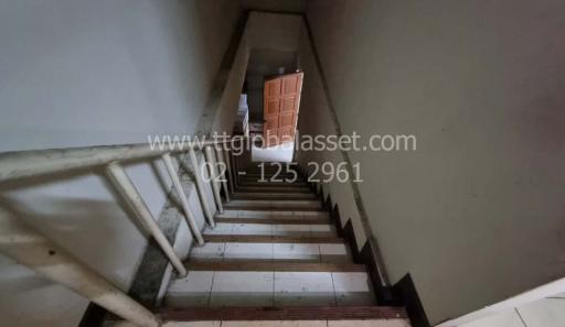 Staircase leading to upper level with wooden door