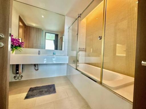 Modern bathroom interior with bathtub and glass shower partition