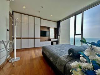 Spacious bedroom with ocean view and modern furnishings