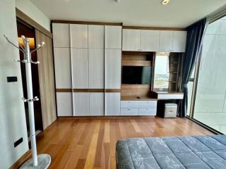 Modern bedroom with built-in wardrobes and wooden flooring