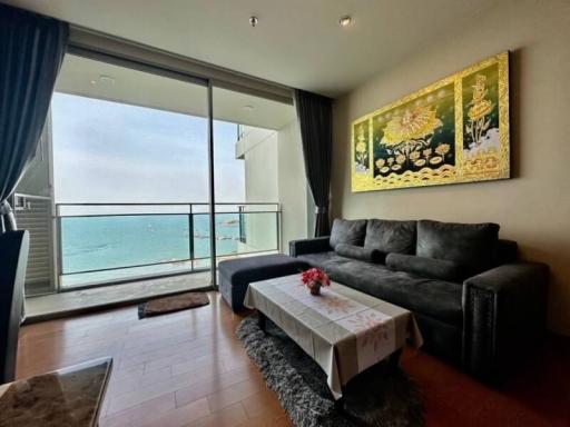 Cozy living room with ocean view, modern sofa and art decor