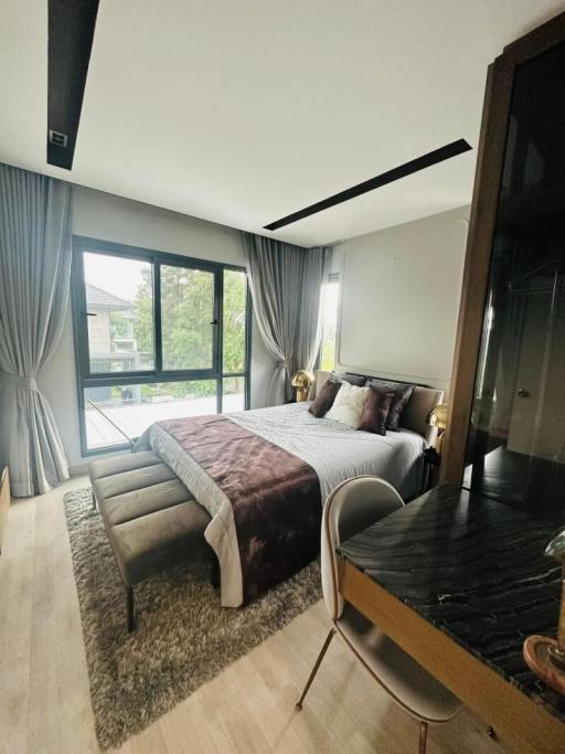 Stylish modern bedroom with large windows and elegant furnishings