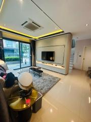 Modern and brightly lit living room with ample seating and entertainment area