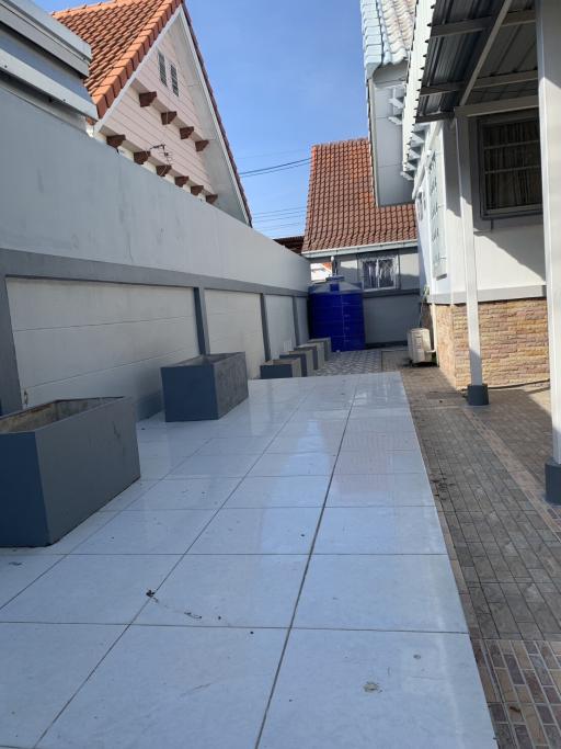 Narrow outdoor alleyway with tiled flooring