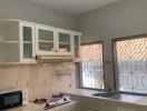 Bright kitchen with windows and modern appliances