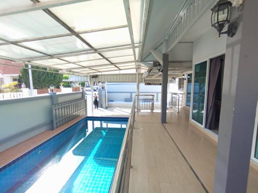 Spacious covered outdoor area with pool and seating