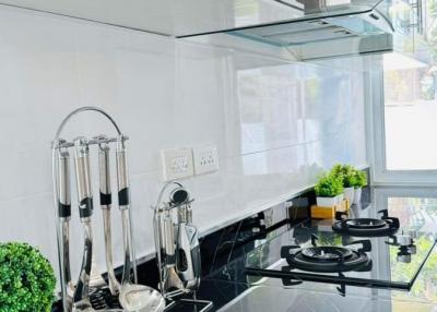 Modern kitchen with white cabinetry and black countertop