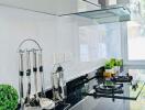 Modern kitchen with white cabinetry and black countertop