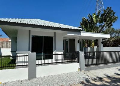 Modern single-family home with white exterior and blue roof