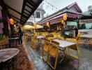 Café outdoor dining area with yellow chairs and festive lighting