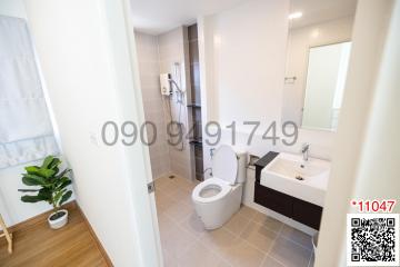 Modern bathroom interior with white fixtures and tiled floor