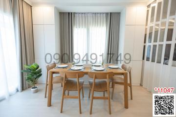 Modern dining room with table set for four and natural light