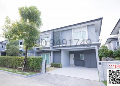 Modern two-story house with a driveway and landscaped front yard