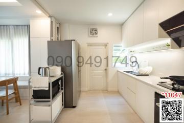 Modern kitchen with stainless steel appliances and white cabinetry