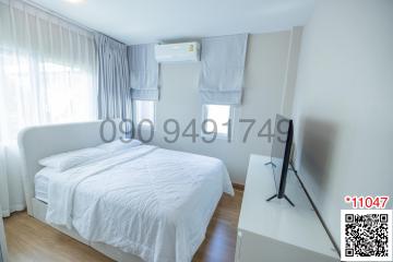 Modern bedroom with natural light and air conditioning