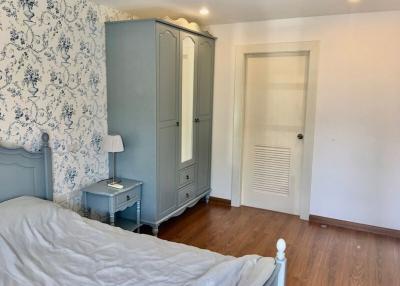 Cozy bedroom with elegant vintage wallpaper and classic furnishings