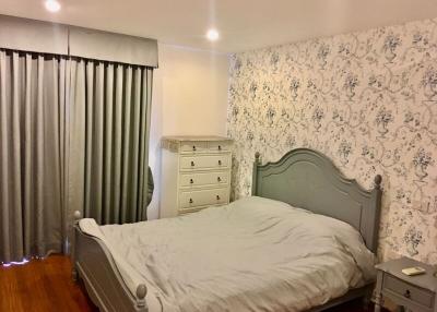 Cozy Bedroom with Queen Bed and Elegant Wallpaper