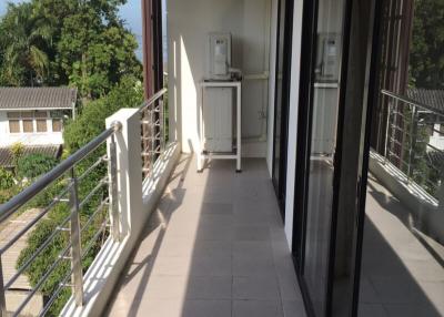 Spacious balcony with view and an outdoor air conditioning unit