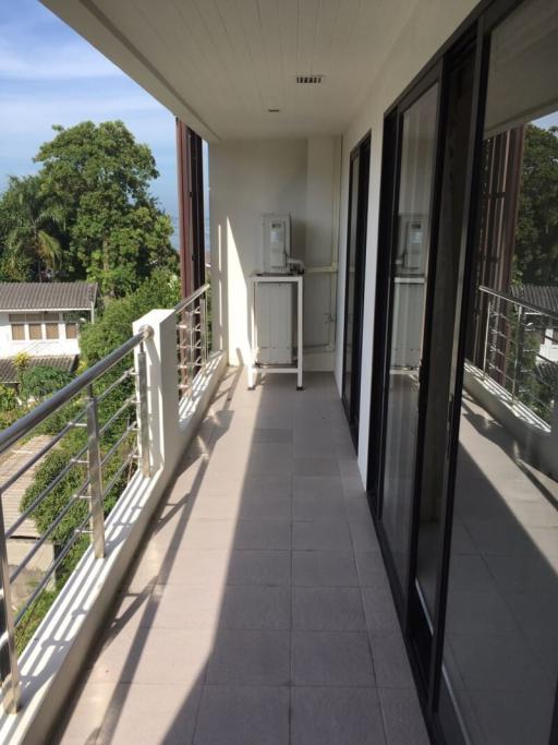 Spacious balcony with view and an outdoor air conditioning unit