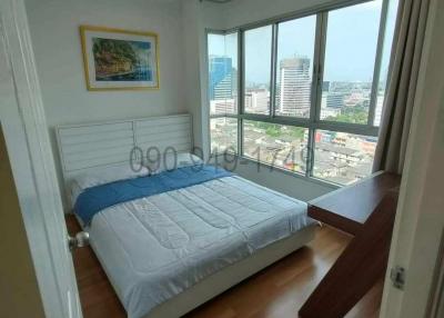 Bright bedroom with large window and city view