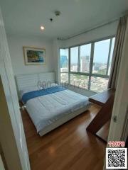 Bright bedroom with large window and city view