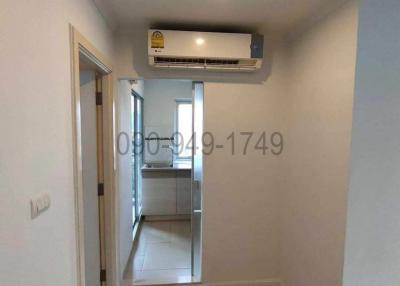 Compact hallway with wooden flooring and built-in air conditioning unit