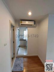 Compact hallway with wooden flooring and built-in air conditioning unit