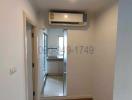 Compact hallway with wooden flooring and built-in air conditioning unit