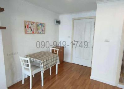 Compact dining room with wooden flooring and white walls