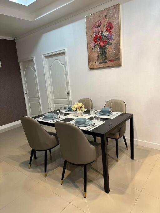 Elegantly set dining table in a modern room with artwork