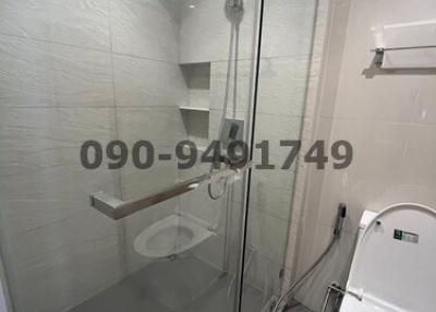 Modern bathroom with glass shower enclosure and tiled walls