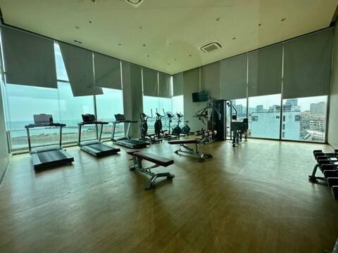 Modern gym facility with exercise equipment and large windows