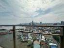 High-rise balcony view overlooking the cityscape and water body