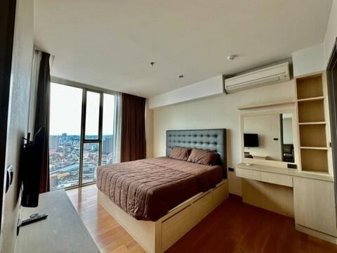 Contemporary bedroom with panoramic city view through large window