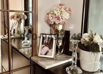 Elegant living room detail with decorative flowers and framed picture