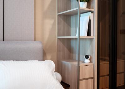 Cozy bedroom with modern shelving unit and sliding wardrobe doors